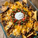 Flavor-Packed Walking Taco Bake served in taco chips, topped with cheese and toppings.